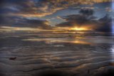 Majestic Sunset Over the Cloudy Beach