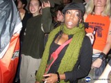 Woman in Green Scarf Stands Out in Crowded City