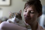 Woman Tenderly Holds Her Green-Eyed Tabby Cat