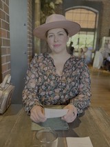 Woman in Floral Blouse at Outdoor Cafe
