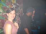 Smiling Woman at Graffiti-Covered Nightclub Wall