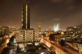 Nighttime Cityscape with High Rise Buildings and Cars