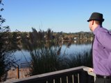 Stylish Man in Fedora Hat by the Waterfront