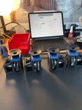 Four small machines on a table