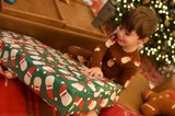 Christmas Morning Joy: Child Opening Festive Present