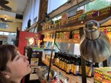 A Woman Contemplating Shelves of Canned Food