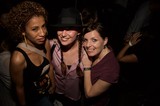 Three Friends Posing Together at a Nightclub Event