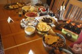 A Feast for the Senses Caption: A table piled high with delicious food and decorated with candles, ready for a luxurious dining experience in Altadena, California.