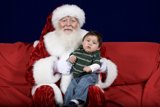 Santa Claus and Child on Festive Red Couch