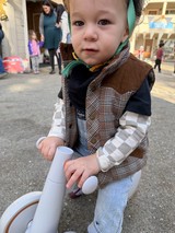 Toddler on Toy Bike at Community Event