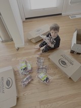 Child Unpacking Broadleaf Food Delivery Boxes
