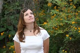 Young Woman Gazing Upward Among Yellow Wildflowers