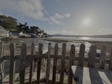 Weathered Wooden Fence Overlooking Coastal Bay