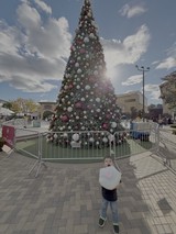 Child with Cotton Candy at Christmas Tree