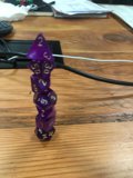 Purple Dice Emblem on Hardwood Table