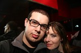 Two Friends Pose Closely at a Dimly Lit Venue