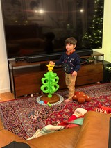 Young Boy Playing with Bright Green Toy Tower