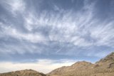 Majestic Mountain Range under a Blanket of Clouds