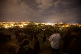 Nighttime Vigil with Cityscape Silhouette