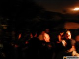 Nightclub Crowd Huddled Under Umbrella