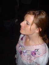 Young Woman Gazing Upward in Dark Setting