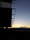 Sunset Silhouette of a Building with a Plane flying over