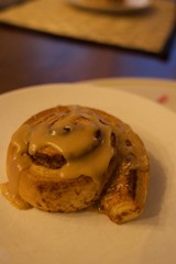 Glazed Cinnamon Roll with Icing on White Plate