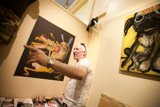 Man admiring fascinating bird painting
