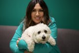 Woman and her white bichon-poodle mix