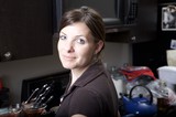 Woman in Kitchen Glances Over Her Shoulder