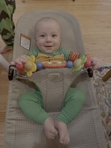 Happy Baby in Bouncy Seat with Toys