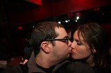 Couple Sharing a Kiss at Dimly Lit Nightclub