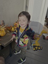 Young Boy Playing with Construction Toy Truck