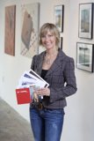 Woman with Folder in front of Artwork