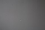 Tiny White Dot on Textured Wall