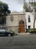 Sporty Coupe Parked in Front of Historic Door