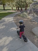 Young Child Learning to Ride Balance Bike