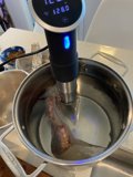 Taking the Heat: Checking Temperature of Mutton in Pan