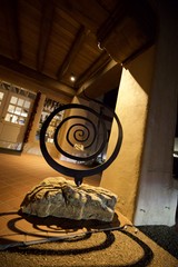 Spiral Sculpture in Warm-Lit Adobe Interior