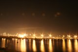 Night Sky Over Lake with Flare and Fireworks