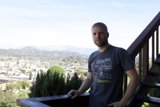 Man enjoying city skyline from deck