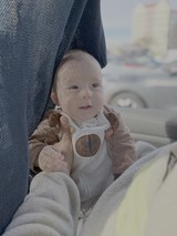 Adorable Baby in Stroller on Sunny Day