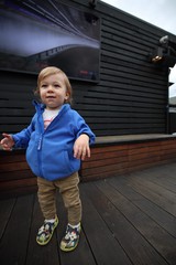 Toddler on Wooden Deck with Modern Building