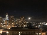 City Skyscrapers Illuminate Under Moonlight