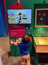 Child Explores Interactive Food Hero Museum Exhibit