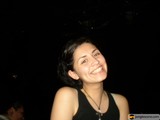 Smiling Woman with Urban Nightlife Background
