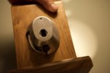 Holding Metal Object on Wooden Surface