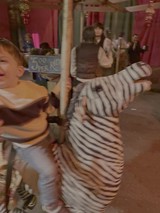 Child Playing on Motion-Blurred Carousel Ride