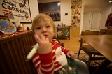 Toddler in Red Striped Pajamas Waving at Camera