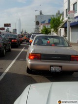 White Sedan Stuck in Traffic